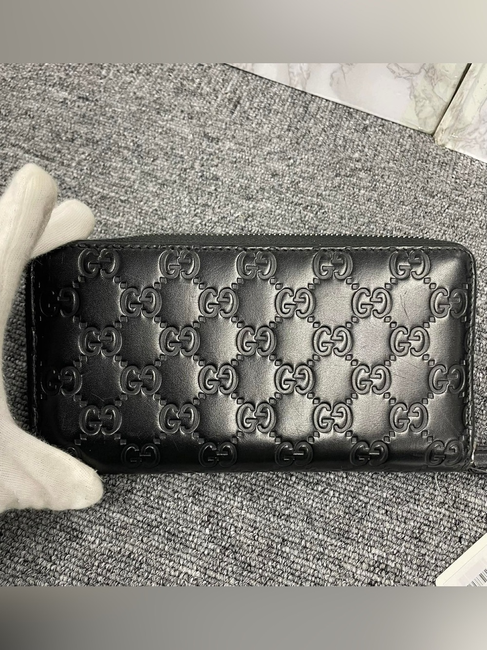 Gucci Black Embossed GG Leather long Zippy Wallet.